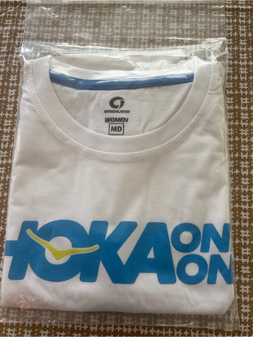 Hoka Women’s Medium Green Layer Brand T Shirt  White with Blue Graphics New